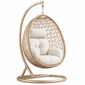 Sillón colgante de ratán con base de acero y cojines color crema